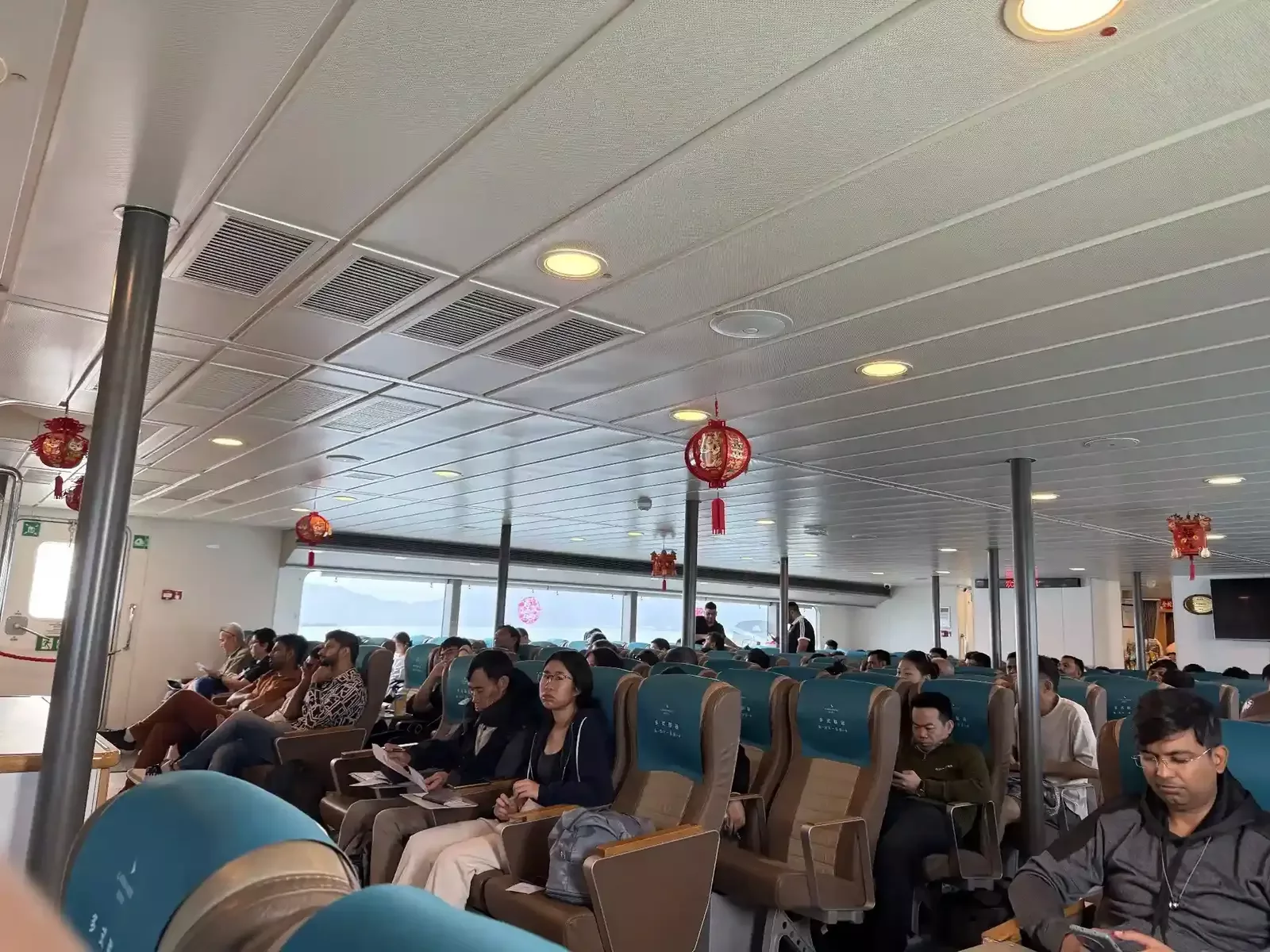 Interior of ferry cabin with passengers traveling to Pazhou, Guangzhou