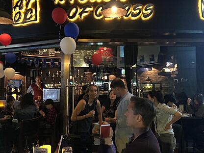 A woman enjoying a drink at A Touch of Class (ATOC) bar in Guangzhou, highlighting the city's upscale nightlife and expat-friendly atmosphere.