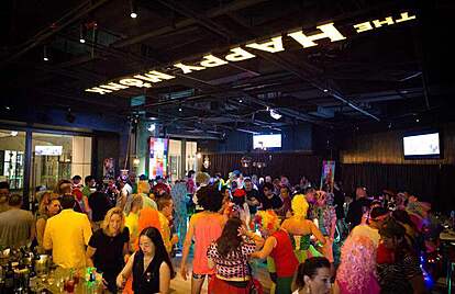 People dancing and enjoying the lively nightlife at Happy Monk in Guangzhou, known for its energetic atmosphere, great drinks, and social vibe.
