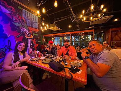 People enjoying Mexican food at Bandidos in Guangzhou, savoring tacos, burritos, and margaritas in a vibrant and lively atmosphere.