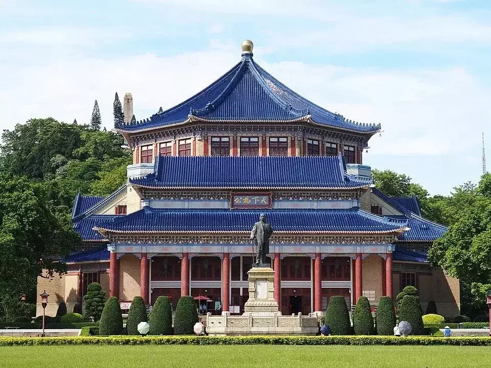 Front facade of Sun Yat-sen Memorial Hall Guangzhou in daylight showing the octagonal main building and blue glazed roof