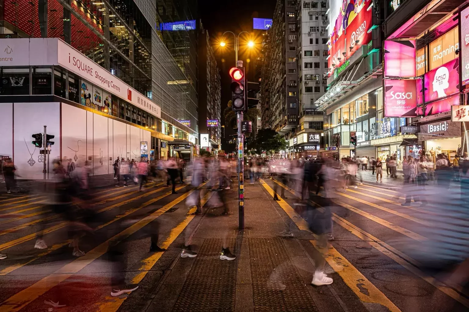 Tsim Sha Tsui Hong Kong busy night street with neon lights and shopping